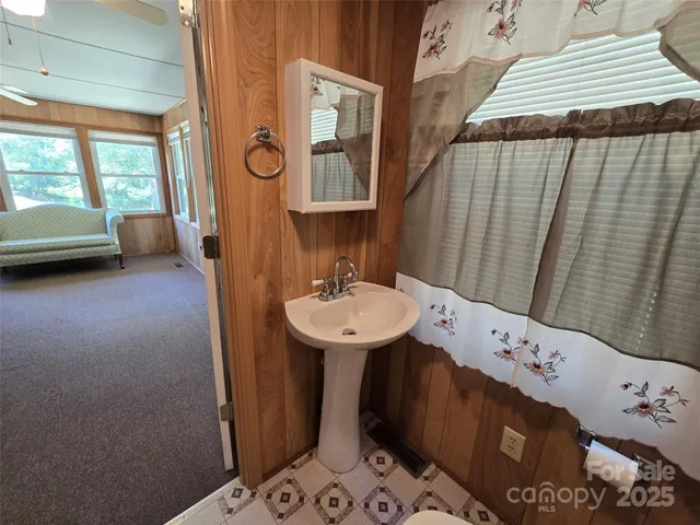 a bathroom with a sink a mirror and a shower