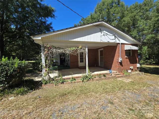 a view of a house with backyard porch and sitting area