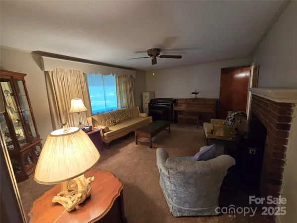 a living room with furniture and a mirror