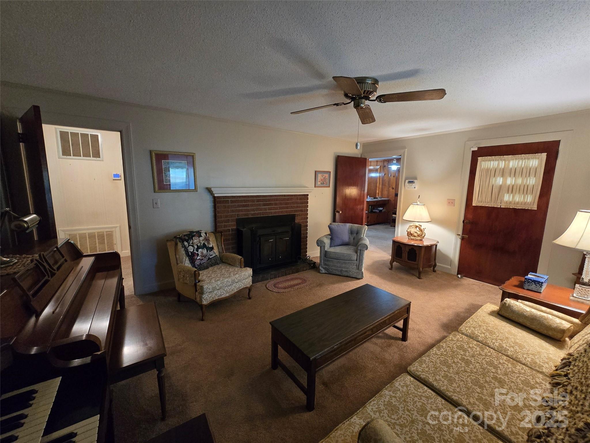 517 Mask Road Mount Gilead, NC 27306 - Photo 5 of 48 a living room with furniture and a fireplace