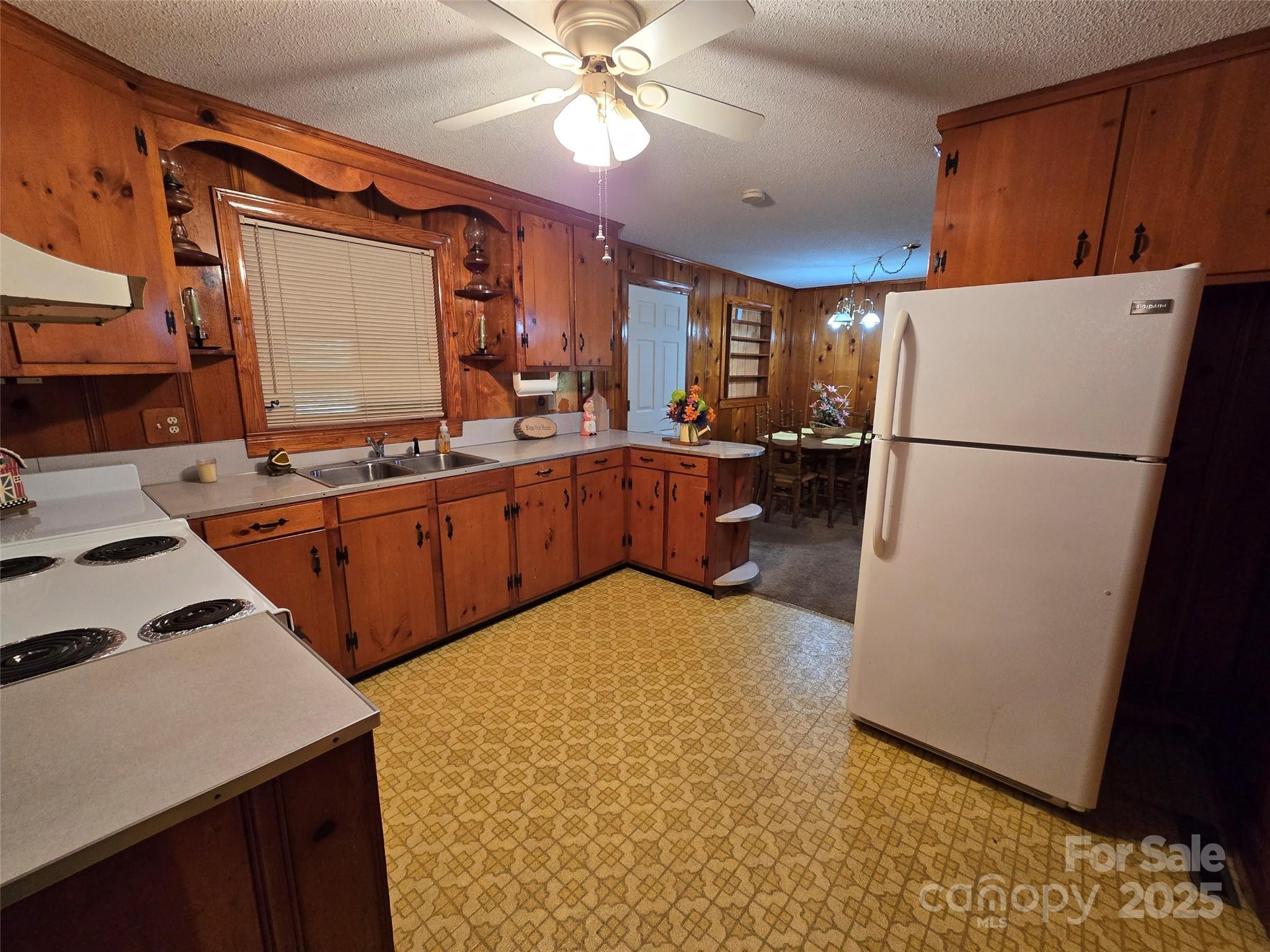 517 Mask Road Mount Gilead, NC 27306 - Photo 9 of 48 a kitchen with a sink a stove and refrigerator
