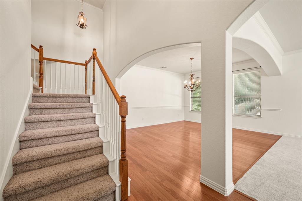808 Briar Ridge Drive Keller, TX 76248 - Photo 6 of 40 Carpeted staircase featuring wood handrails and white balusters