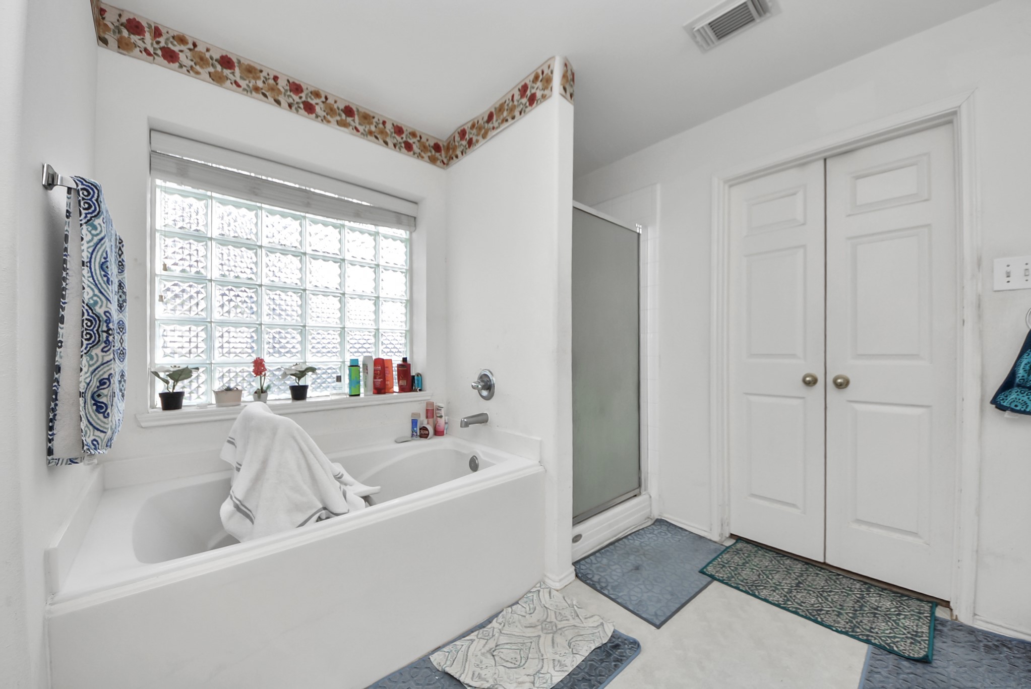 10003 Dakota Ridge Court Houston, TX 77095 - Photo 27 of 30 a bathroom with a bathtub a shower and a sink