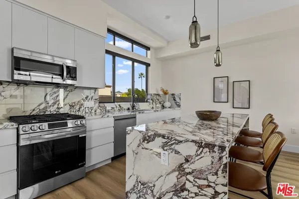a kitchen with stainless steel appliances granite countertop a stove and a sink