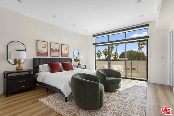 a living room with furniture and a view of bathroom