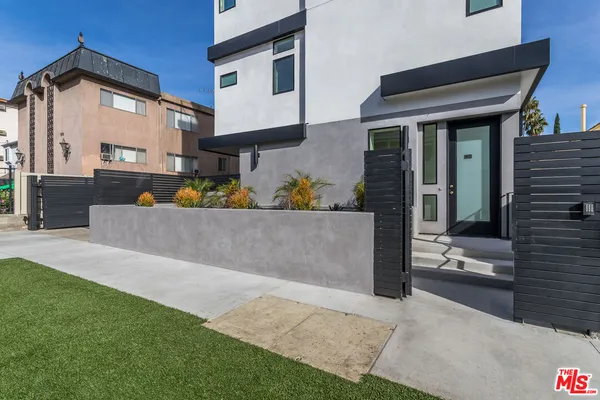 a view of a house with potted plants