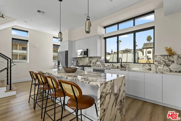 a kitchen with stainless steel appliances granite countertop a sink and stove
