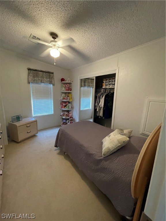 20560 Holiday Drive Estero, FL 33928 - Photo 20 of 33 a bedroom with a bed and a chandelier