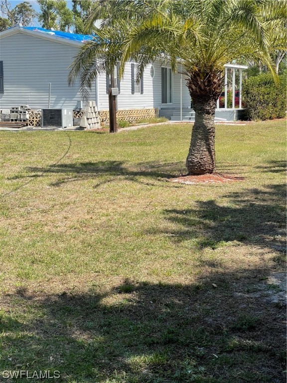 20560 Holiday Drive Estero, FL 33928 - Photo 2 of 33 a front view of a house with a yard