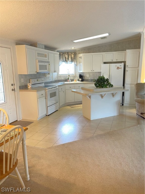 20560 Holiday Drive Estero, FL 33928 - Photo 25 of 33 a large white kitchen with a sink and cabinets