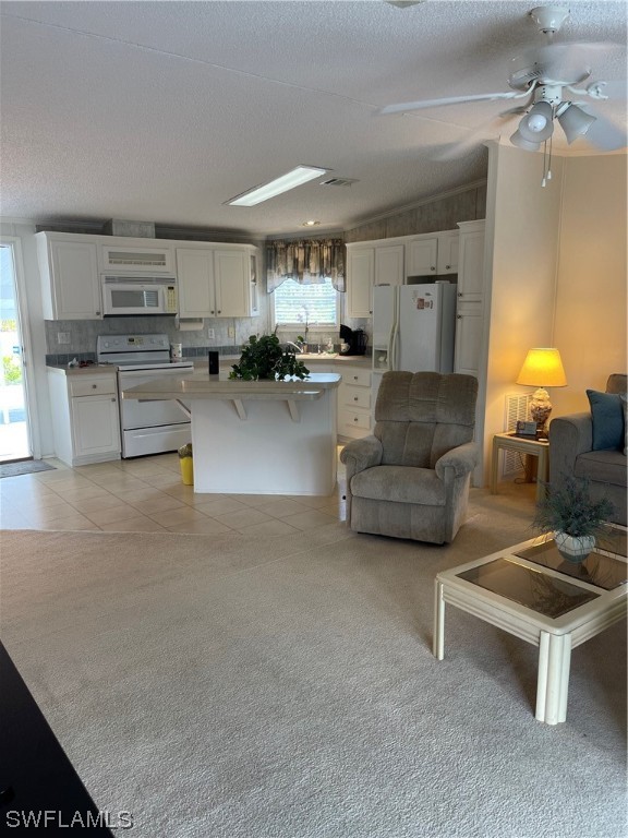 20560 Holiday Drive Estero, FL 33928 - Photo 27 of 33 a living room with furniture and a chandelier