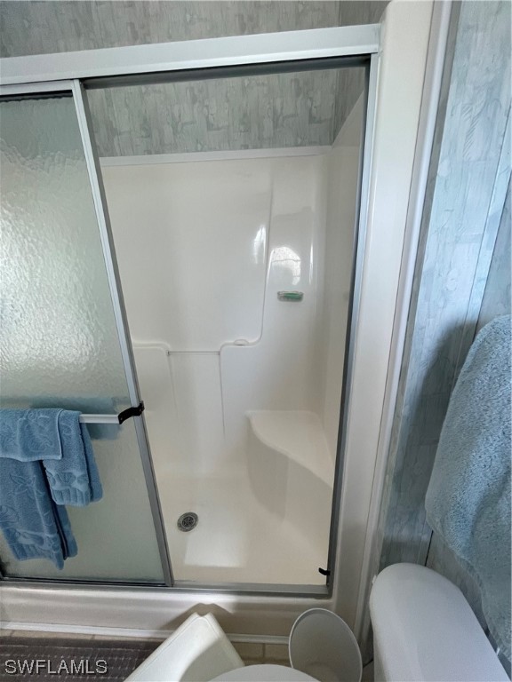 20560 Holiday Drive Estero, FL 33928 - Photo 7 of 33 a bathroom with a shower and toilet
