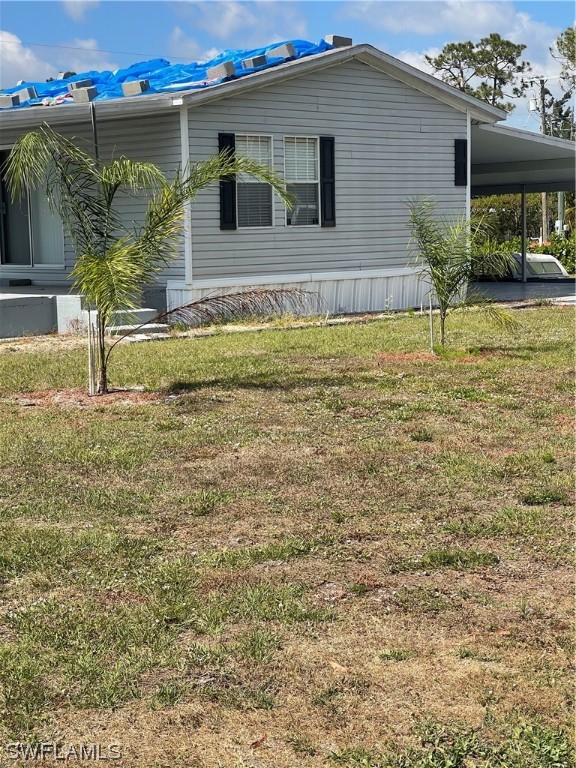 20560 Holiday Drive Estero, FL 33928 - Photo 10 of 33 a front view of a house with garden