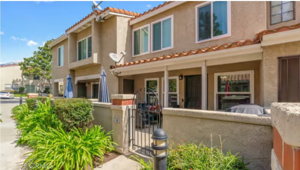 8167 Vineyard Avenue, Unit 34 Rancho Cucamonga, CA 91730 - Photo 1 of 1 front view of a brick house with a large window