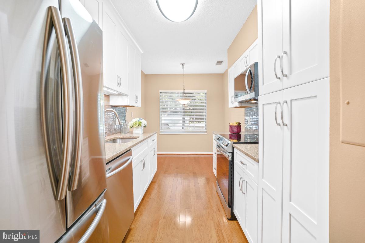 14809 Pennfield Circle, Unit 105 Silver Spring, MD 20906 - Photo 12 of 29 a kitchen with stainless steel appliances a refrigerator and a stove