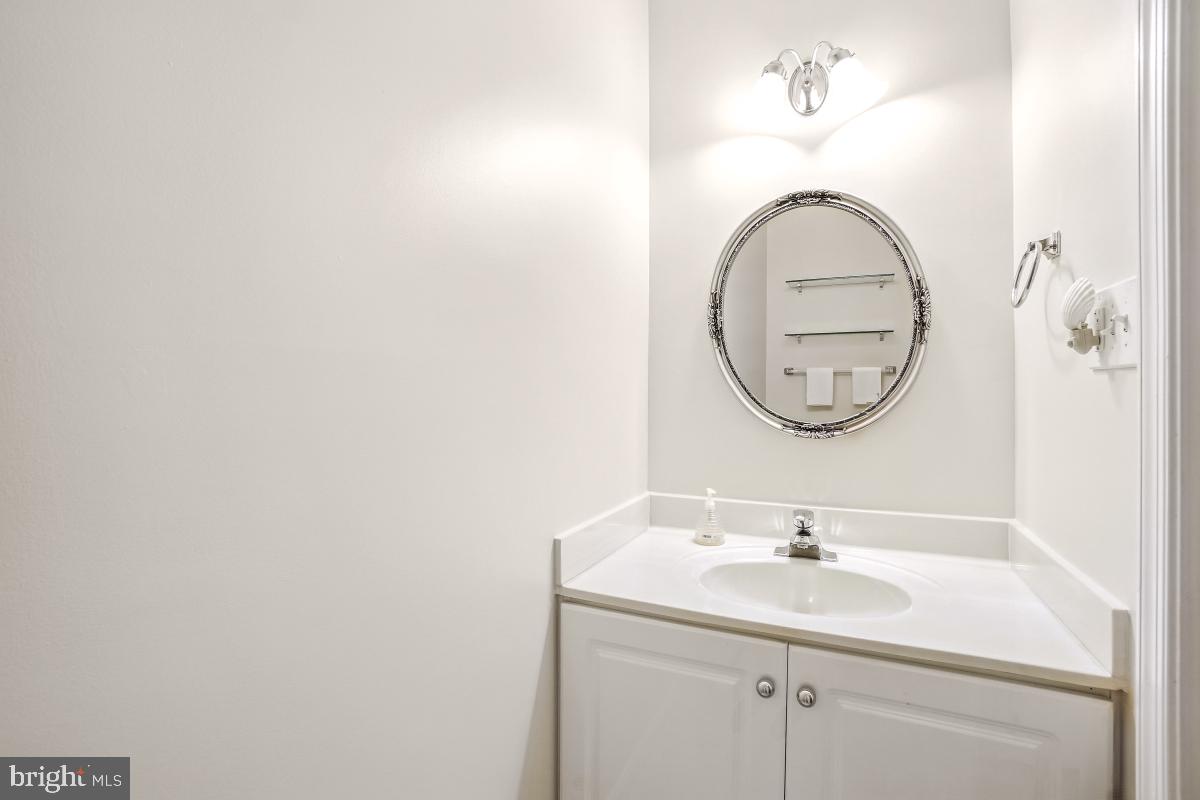 14809 Pennfield Circle, Unit 105 Silver Spring, MD 20906 - Photo 16 of 29 a bathroom with a sink and a mirror