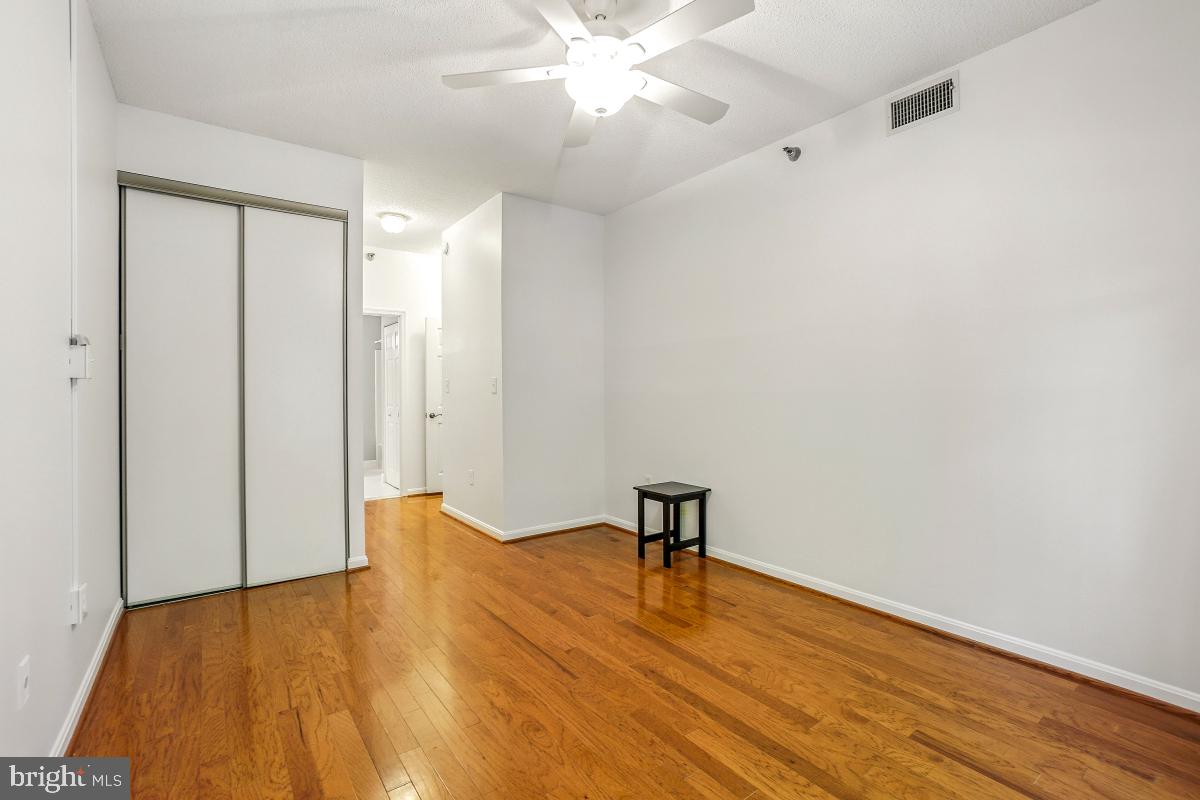 14809 Pennfield Circle, Unit 105 Silver Spring, MD 20906 - Photo 20 of 29 a view of empty room with wooden floor