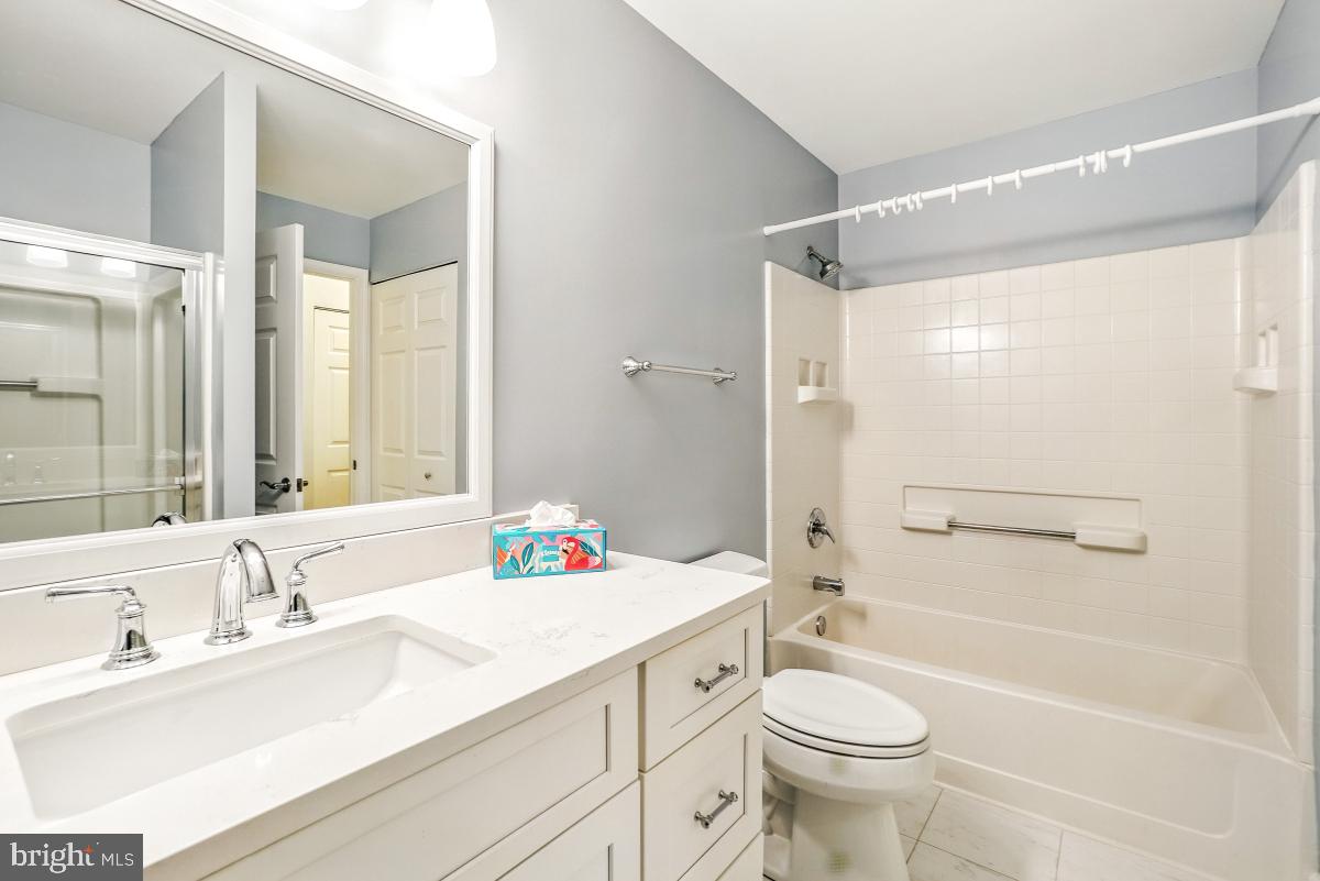 14809 Pennfield Circle, Unit 105 Silver Spring, MD 20906 - Photo 22 of 29 a bathroom with a sink a toilet and shower