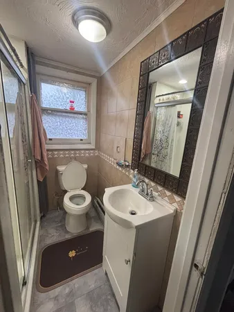 a bathroom with a toilet and a shower