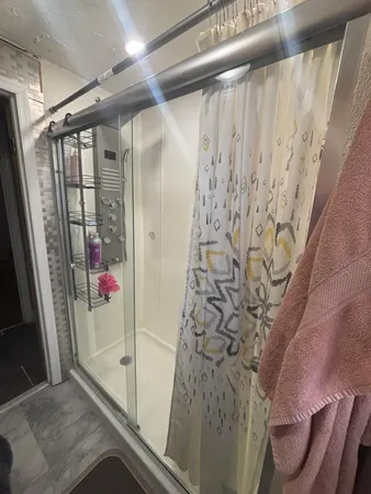 a bathroom with a sink and mirror with bathtub
