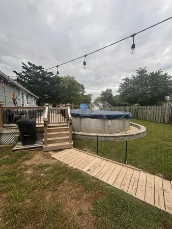 a house view with swimming pool in front of it