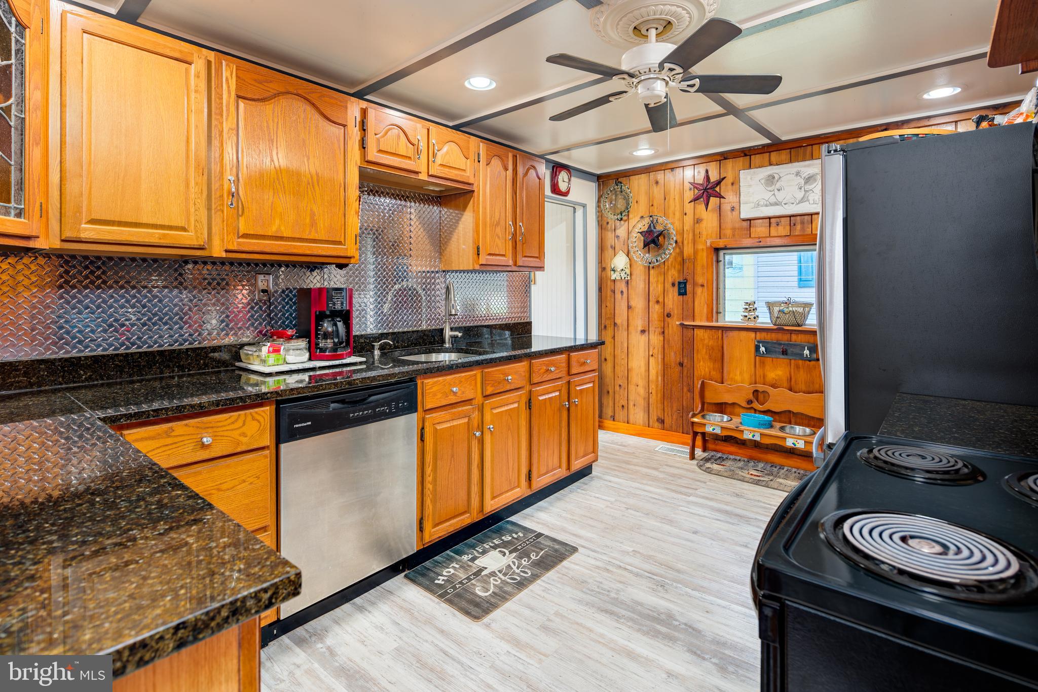 325 Main Street Delta, PA 17314 - Photo 11 of 41 a kitchen with stainless steel appliances granite countertop a sink stove and refrigerator