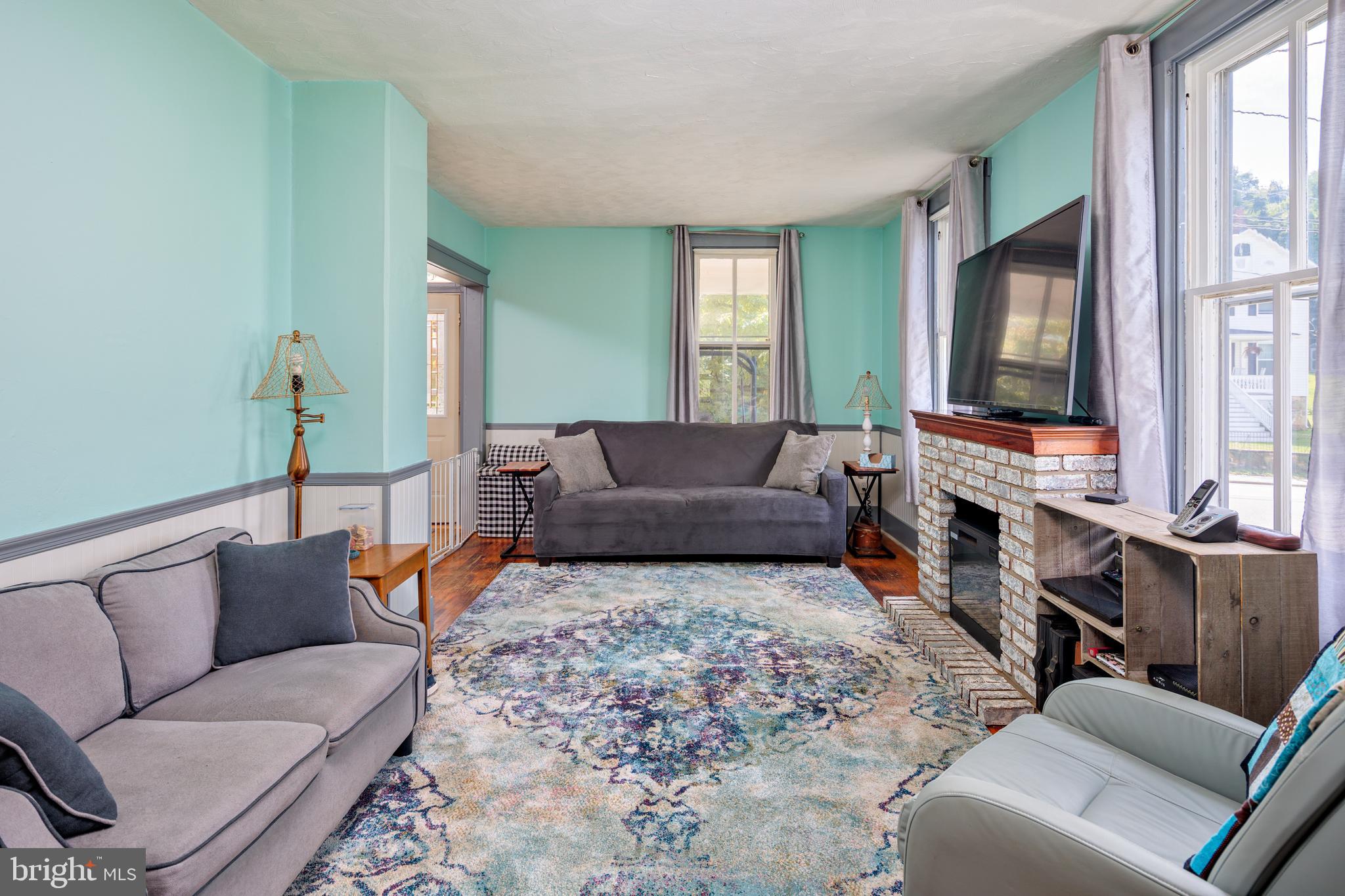 325 Main Street Delta, PA 17314 - Photo 4 of 41 a living room with furniture wooden floor and a flat screen tv