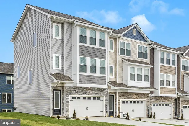 a front view of a building with a yard