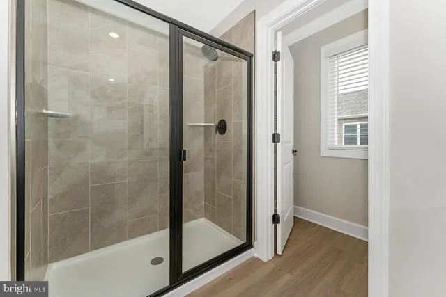 a bathroom with a glass shower door