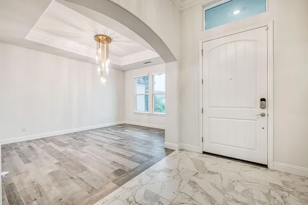 a view of an empty room with cabinet and entryway