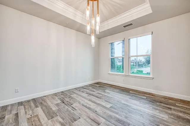 a kitchen with white cabinets and oven