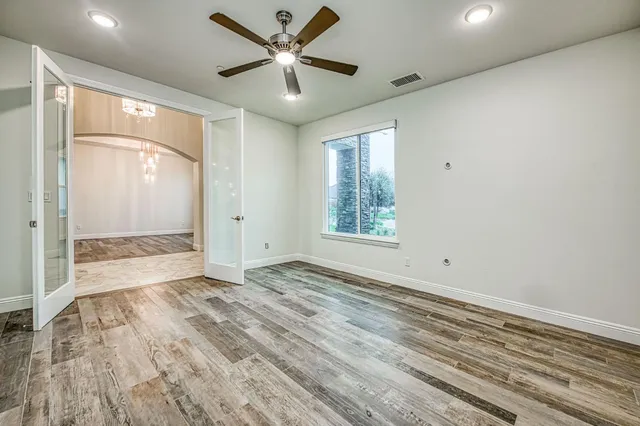 a view of a patio with a table and chairs under an umbrella