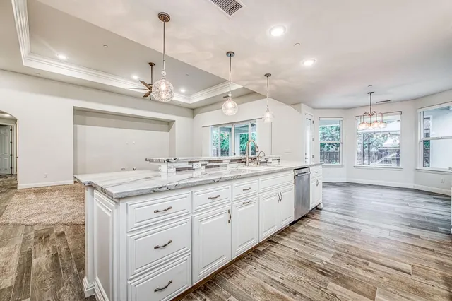 a view of an empty room with cabinet and entryway
