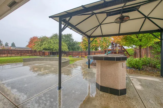 a large kitchen with kitchen island a stove a sink a center island and a wooden cabinets
