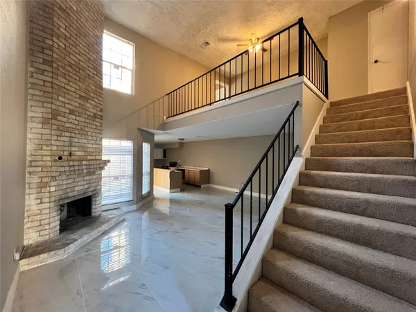 a view of entryway with wooden floor and stairs