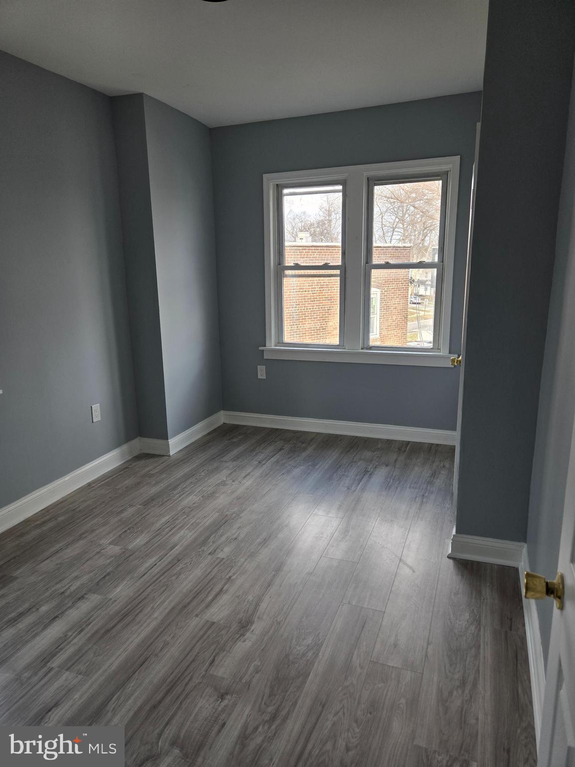 933 Keystone Road Chester, PA 19013 - Photo 8 of 8 an empty room with wooden floor and windows