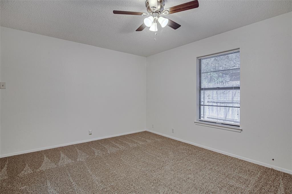 1312 Ridge Run Street, Unit A Cleburne, TX 76033 - Photo 13 of 16 an empty room with a window and a fan