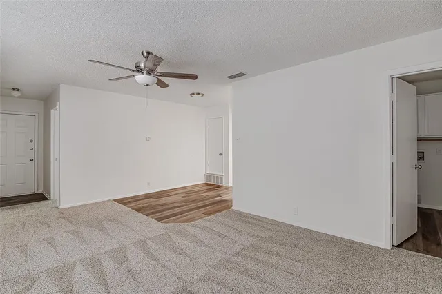 a view of room with a ceiling fan
