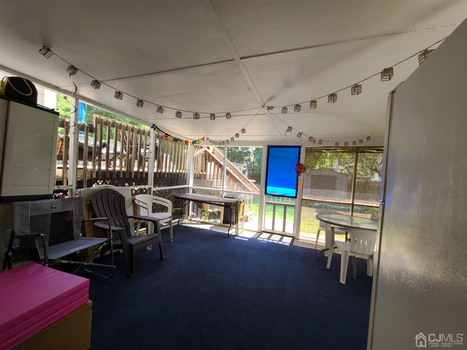 8 Chelsea Road Old Bridge, NJ 08857 - Photo 14 of 15 a roof deck with table and chairs