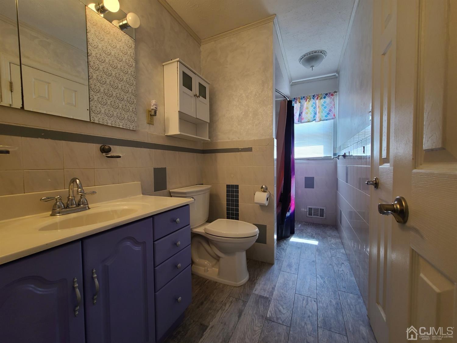 8 Chelsea Road Old Bridge, NJ 08857 - Photo 4 of 15 a bathroom with a sink a toilet and mirror
