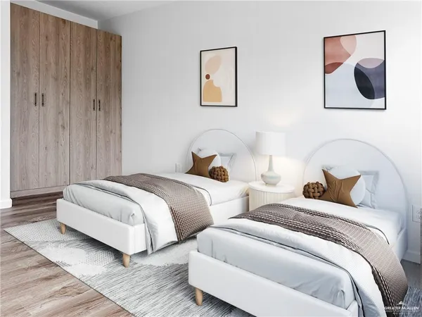 a bedroom with two beds and painting on the wall