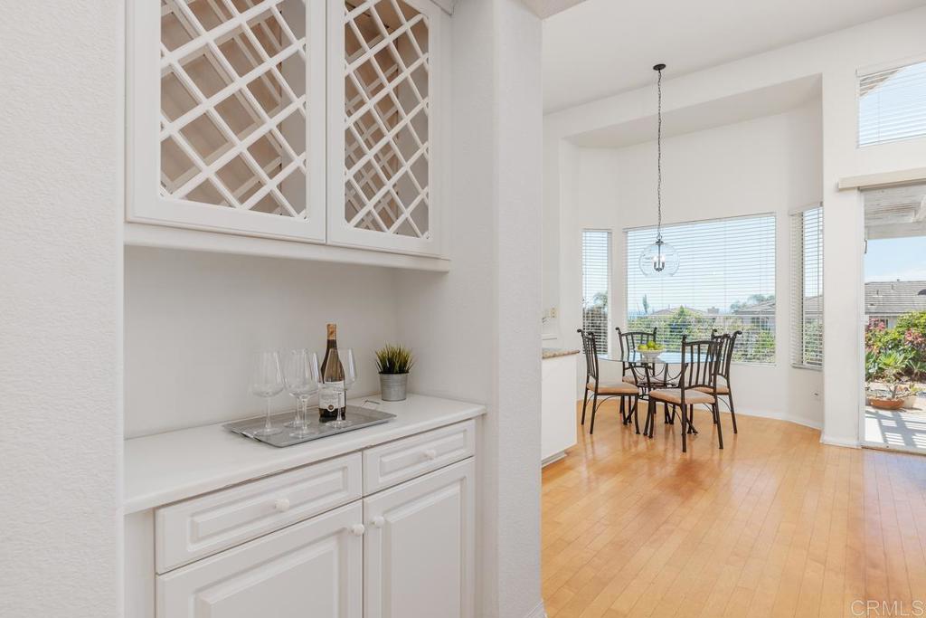 250 Pacific View Lane Encinitas, CA 92024 - Photo 12 of 40 a kitchen with a sink a table and chairs