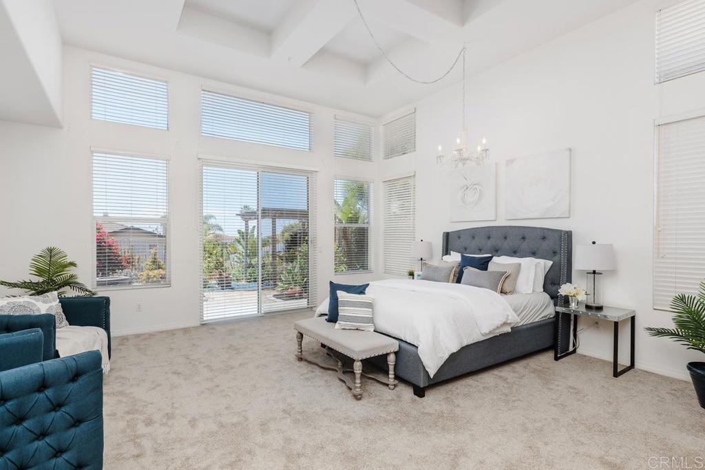 250 Pacific View Lane Encinitas, CA 92024 - Photo 21 of 40 a spacious bedroom with a bed and a large window