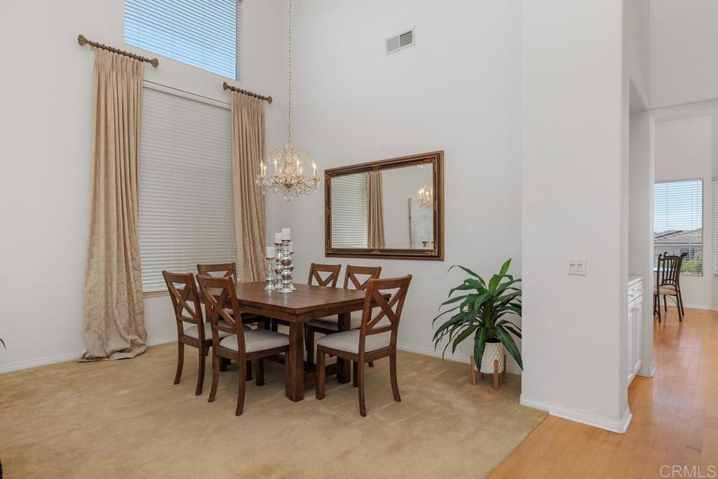 250 Pacific View Lane Encinitas, CA 92024 - Photo 10 of 40 a view of a dining room with furniture and wooden floor