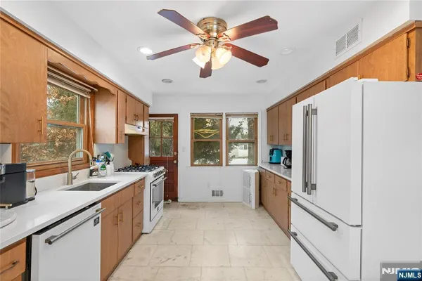 a large white kitchen with a large window