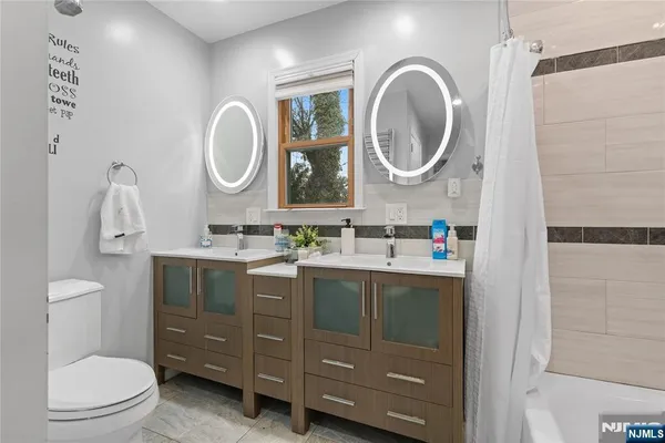 a bathroom with a toilet a sink and a mirror