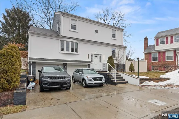 a car parked in front of a white building