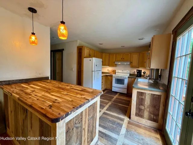 a kitchen with stainless steel appliances granite countertop a stove a refrigerator and a microwave