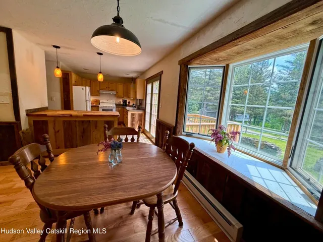 a dining room with furniture and wooden floor