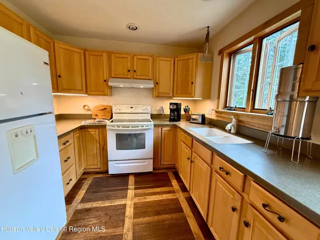 a kitchen with a stove a sink and a refrigerator